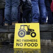 Members of the farming community protest outside the Senedd in Cardiff over planned changes to farming subsidies.