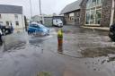 Cars making their way through flooding on Strand in Cardigan.