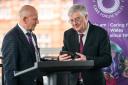 Mario Kreft MBE, the chair of Care Forum Wales, presenting former First Minister Mark Drakeford with a Wales Care Award
