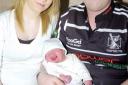 Mum Catrin James and Dad Shaun Kendrick with their snow baby.