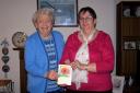 Marjorie Davies is pictured donating the cheque for £780 to Maimie Davis of the Motor Neurone Disease Association.