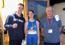 A delighted Caitlin Fraser is pictured with Cardigan cornermen Garan Croft and head coach Guy Croft.