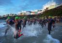The sunrise swim start of Ironman Wales in Tenby is one of the event's iconic features.