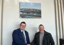 Adrian Andrews and Alan Rees-Baynes with one of the paintings at Dulse @Ty Hotel on Milford Waterfront