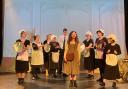 Some of the cast of Annie, with Polly Devonald playing Annie centre.