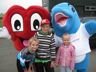 Hearty from the British Heart Foundation meets Finn the dolphin from Bluestone and children watching the start of the Pembrokeshire County Run.