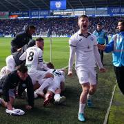 Swansea City's Liam Cullen and team-mates celebrate after Ben Cabango scored their side's third goal of the game at the Cardiff City Stadium, Cardiff.