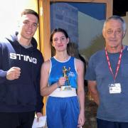 A delighted Caitlin Fraser is pictured with Cardigan cornermen Garan Croft and head coach Guy Croft.