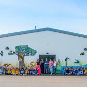 Some of the children at Neyland Community School with their wonderful new mural