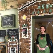 Café manager Tiggy Williams with the edible gingerbread house at Stopio café