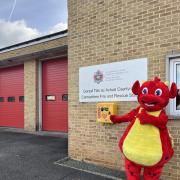 Sbarc the mascot with the ldefibrillator installed at Carmarthen fire station