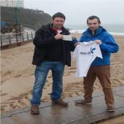 Splash Out organiser Angelo Fecci (right) is presented with Tenby Round Table's cheque by Tabler Nick Joseph.