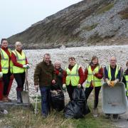 Simon Hart MP with staff and volunteers from the National Trust and ranger Carol Bailey clear up at Morfa Bychan, near Pendine.