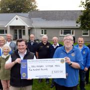 Tenby and District Lions chairman Rob Mayhew presents the £500 cheque for New Hedges play area to village hall chairman Howard Rawson-Humphries,. PICTURE: Gareth Davies Photography.