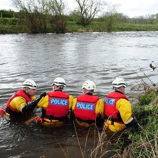 A specialist police search team searches the River Wear after an eight-year-old boy fell into the swollen river