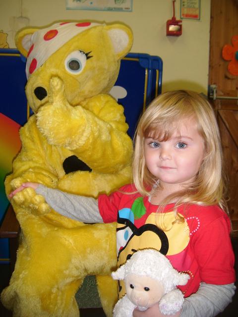 Two and a half year old Shaiya Rose Ablitt holds hands with Pudsey.