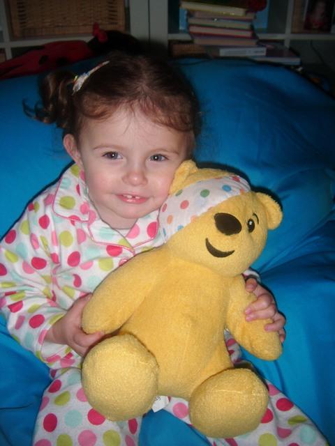 In her spotty pyjamas is two-year-old Kayla Kemp from Honeyborough with Pudsey.