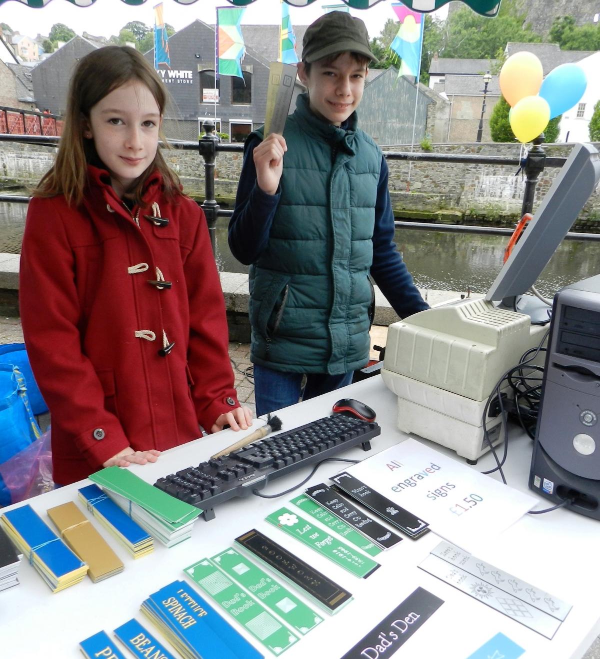 The home-schooled Pamment-Jones family had their own stall with P-Jay's engraved gifts. 13-year-old Lewis, pictured with Zara, used an engraving machine on site to produce signs, plant markers and bookmarks with messages 