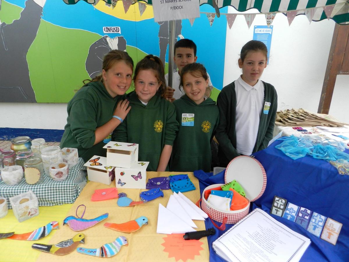 Pupils from St Mary's School, Pembroke Dock, with some of the items on their stall including colourful birds and tealight holders.
