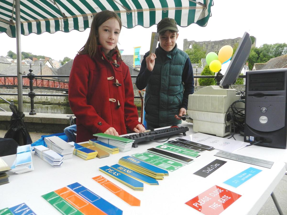 The home-schooled Pamment-Jones family had their own stall with P-Jay's engraved gifts. 13-year-old Lewis, pictured with Zara, used an engraving machine on site to produce signs, plant markers and bookmarks with messages