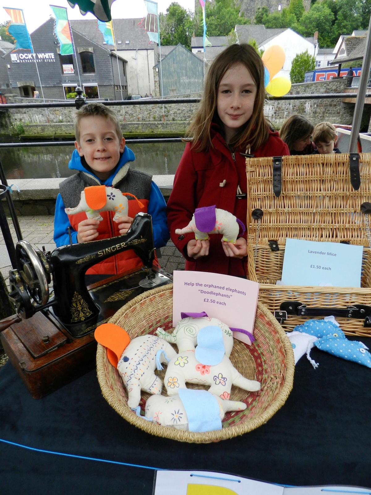 The home-schooled Pamment-Jones family had their own stall. Zara, 10, used a hand powered Singer sewing machine to make colourful elephants being sold in a good cause. She is pictured with Freddie, 9.
