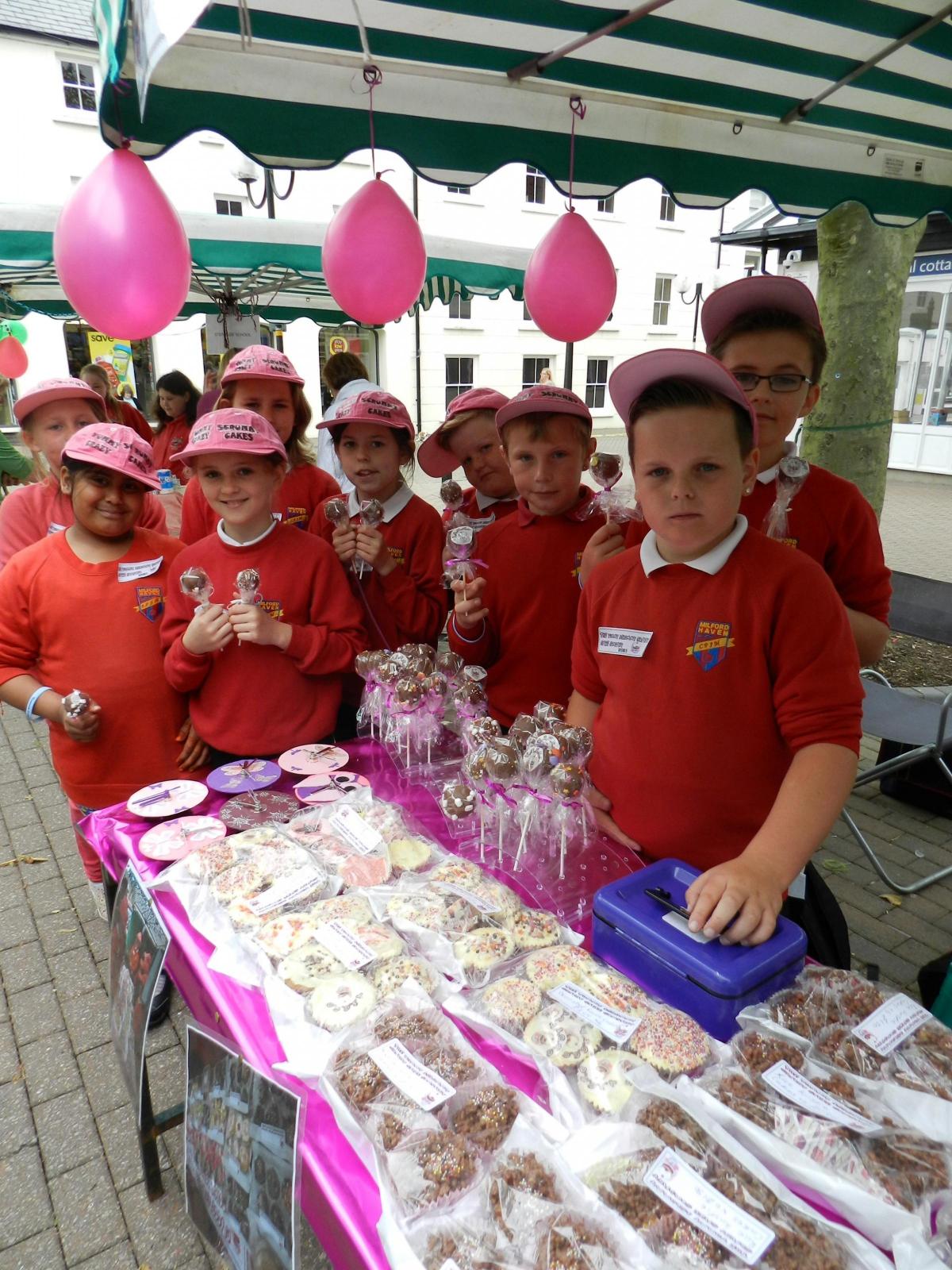 The Yummy Scrummy Crazy Cake Company from Milford Haven Junior School looked very professional with their pink branded  baseball caps and special cakes and labels.