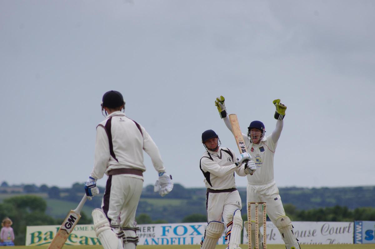 Whitland keeper Blain celebrates the first innings wicket of Sutton.