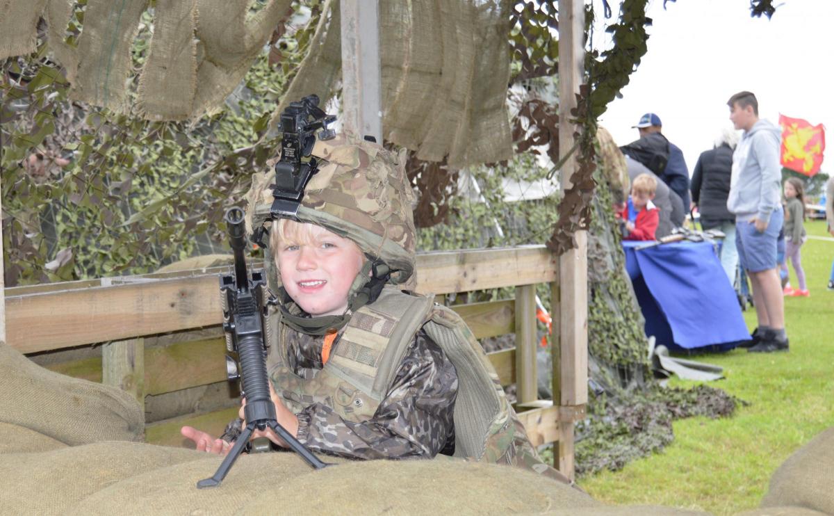 Osian James, aged 4, poses in army gear.