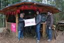 Pictured with the National Lottery cheque in the shelter of The Milkwood Project's new roundhouse are project secretary Lynne Crompton, director Lee Burton and treasurer Gideon Petersen.