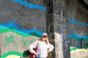 .Artist Liz Tobin is pictured with the mural's first outlines.