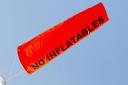 The orange windsock warns of strong offshore winds.