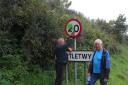 Martletwy residents Geoff Sinclair and Michael Carpenter get to work on cleaning one of the vandalised signs.