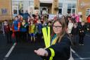 Saundersfoot CP School pupils are pictured on the Stride to School wearing their slapbands, sponsored by South Hook LNG, with school crossing patrol officer Sylvia Price and Helen Luff from the council’s road safety team.