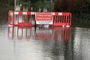 Police are urging drivers to abide by closed road signs on flooded streets
