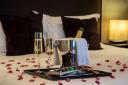 The package includes rose petals, a love spoon and a bottle of prosecco