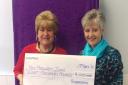 Pembrokeshire Lottery manager Abigail Owens presents Margaret John with her £8,000 winning cheque.