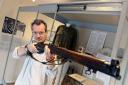 Tenby Museum's Mark Lewis gets his sights on a World War One rifle which is on display in the latest exhibition. PICTURE: Gareth Davies Photography