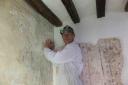 Peter Martindale works on the wall paintings conservation project at the Tudor Merchant’s House. PICTURE: National Trust.