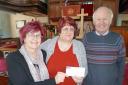 Georgia Wilson is pictured receiving a cheque from the elders of Tabernacle U R C Pembroke, Kathryn Harries and Edward Harries.
