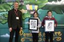 Margaret Jones’ son Mark with pupils at Prendergast CP School and some of her artworks gifted to the school.