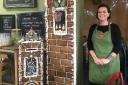 Café manager Tiggy Williams with the edible gingerbread house at Stopio café
