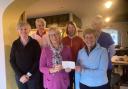 Outgoing lady captain, Susan Waterhouse, presents a cheque for £900 to Sylvia Hotchin, chairperson of Fishguard and Goodwick RNLI fundraisers, accompanied by incoming lady captain Kate Rotherford (far left) and other members of the golf committee