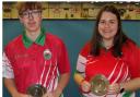 Katie and Rhys with the commemorative salvers marking their debuts with the Wales mixed Under 18s indoor team.