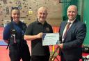 PCSO Laura Edwards, and PCC Dafydd Llywelyn presenting certificate to Chris McEwen of BOXWISE.