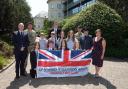 Military children from  Haverfordwest High VC School and Prendergast Community School with members of 14th Signal Regiment, 948 Squadron RAF Cadets, and Pembrokeshire council staff.