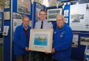 Air Commodore Adrian Williams receiving the Sunderland T9044 print from Heritage Trust Chairman Graham Clarkson (right) and Patron John Evans.