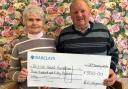 Bryn Vaughan and his wife Jean are pictured with the £350 cheque for BHF Cymru.