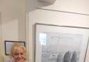 Theatr Gwaun trustee Blanche Giacci is pictured alongside one of the works on display.