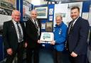 The Sunderland cake is shown by John Evans, Patron of the Pembroke Dock Heritage Trust, to (left to right) Councillors Steve Alderman and Tom Tudor and Sam Kurtz, MS..