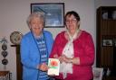 Marjorie Davies is pictured donating the cheque for £780 to Maimie Davis of the Motor Neurone Disease Association.